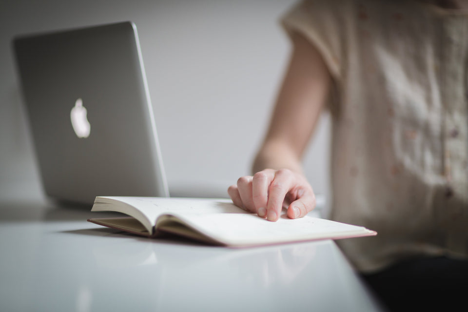 Learning English online using your laptop and book to study for your class on Zoom